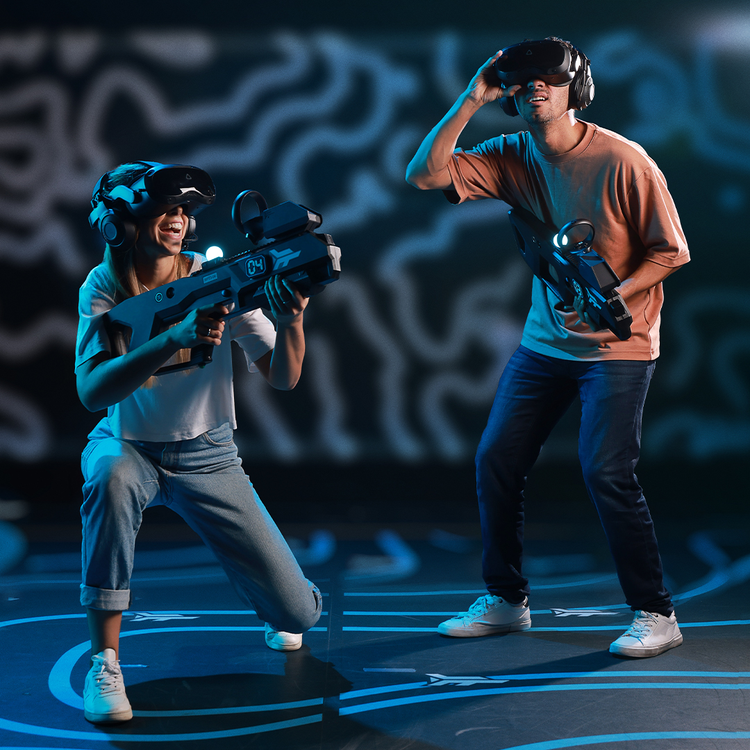 Two guests playing Zero Latency VR with headsets and controllers