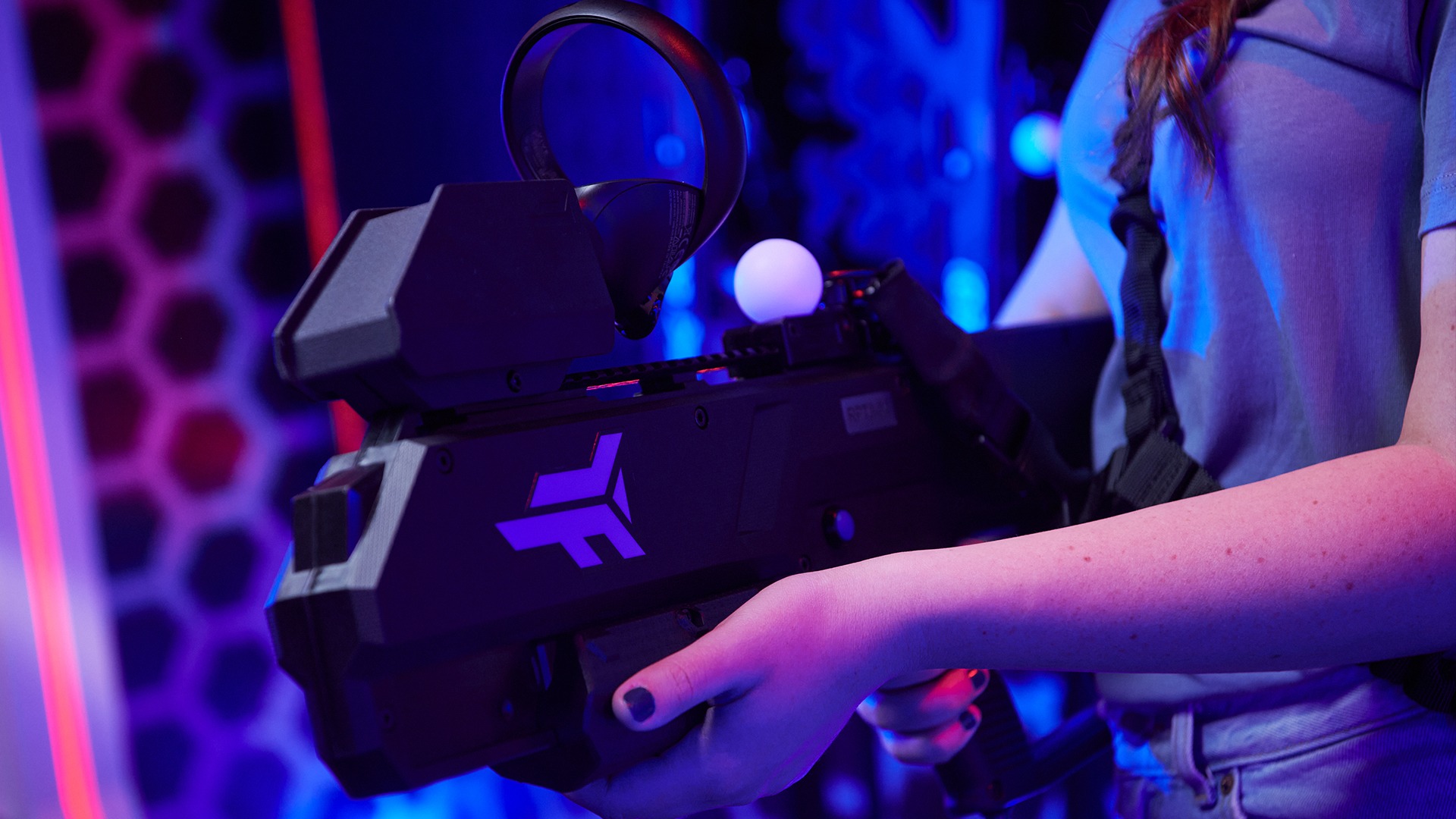 Close-up of a Zero Latency VR handheld controller with glowing tracking marker